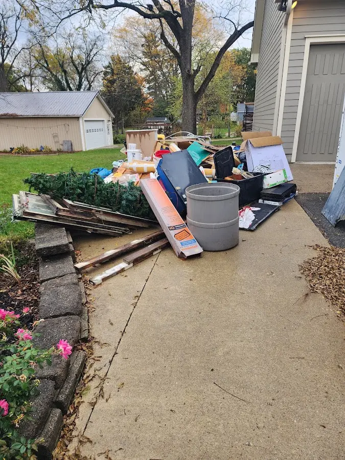 Dumpster being loaded with debris for 3 Yard Dumpster Rental in Hamilton